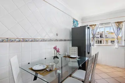 a dining room with a glass table and chairs at Villa Calipso in Albufeira