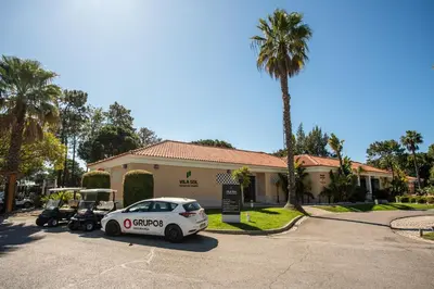 a car parked in front of a house with a golf cart at Villa Simone by Intiholidays in Quarteira