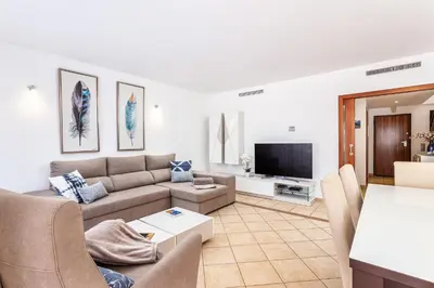 a living room with a couch and a tv at Villa Simone by Intiholidays in Quarteira