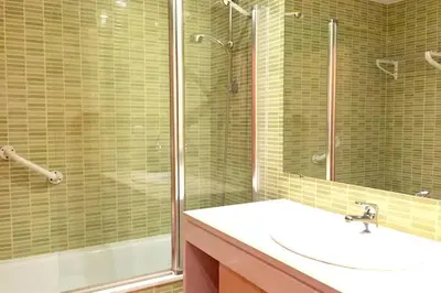 a bathroom with a sink and a shower at Albufeira parque da CORCOVADA standing flat W/Pool in Albufeira