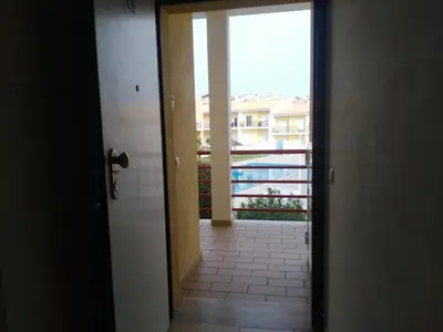 a door to a balcony with a view of a pool at Salgados Sea View Apartment in Albufeira