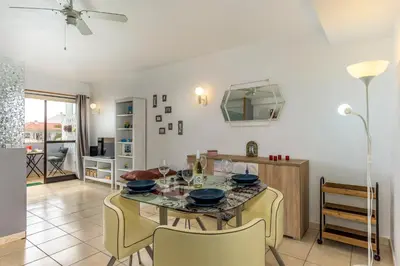 a kitchen and dining room with a table and chairs at FLH Albufeira Balcony Flat with Pool in Albufeira