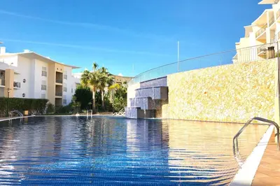 a swimming pool in front of a building at Albufeira l encosta da Orada wonderful sea view in Albufeira