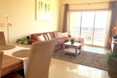 a living room with a couch and a table at Albufeira l encosta da Orada wonderful sea view in Albufeira