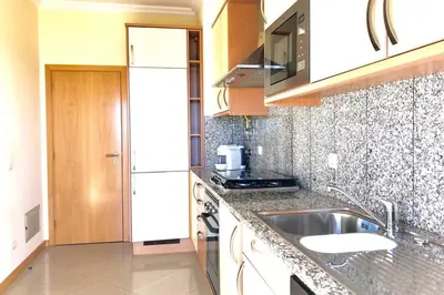 a kitchen with a sink and a counter top at Albufeira l encosta da Orada wonderful sea view in Albufeira