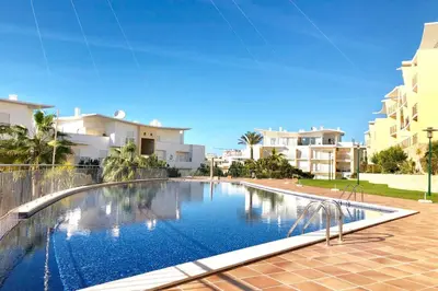 a large swimming pool in front of some buildings at Albufeira l encosta da Orada wonderful sea view in Albufeira