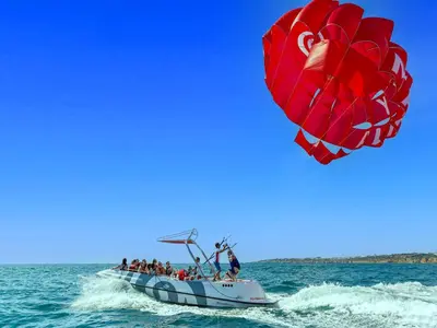 a group of people on a boat with a large kite at V4, Villa Jardins Branqueira3 near Beach, Albufeira in Albufeira