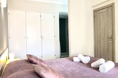 a bedroom with a purple bed with two pillows on it at Poente da Aldeia apartment in Albufeira
