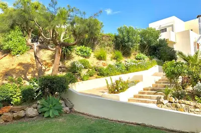 a garden with stairs and trees and a building at Poente da Aldeia apartment in Albufeira