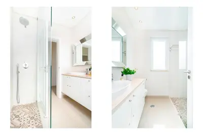 a white bathroom with a sink and a shower at WHome | Prime Hideaway Luxury Villa in Quarteira