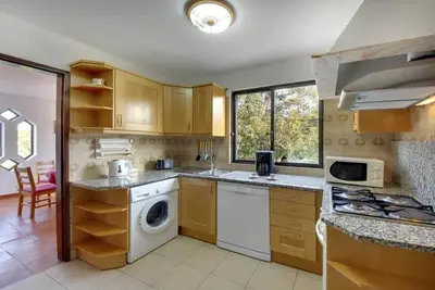 a kitchen with a washer and dryer at VILLA COELHO in Albufeira