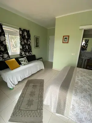 a bedroom with two beds and a window at Casa da azinheira in Loulé