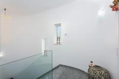 a room with a glass partition and a vase at Villas Mar e Brisa in Albufeira