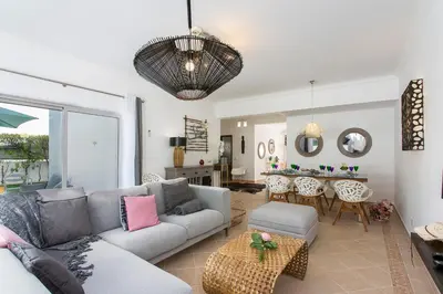 a living room with a couch and a table at Villas Mar e Brisa in Albufeira
