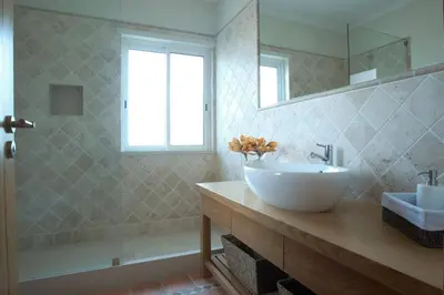 a bathroom with a white sink and a mirror at Villa Mayfair - Quinta do Lago in Almancil