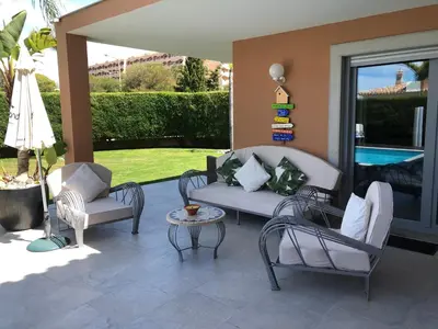 a patio with chairs and a couch and a table at Casa Corais in Guia