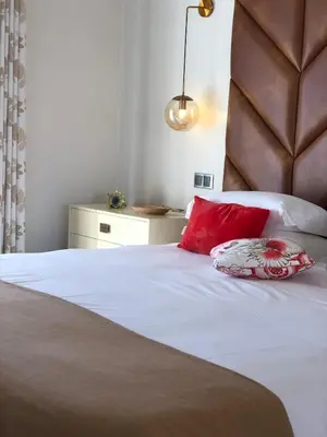 a bed with two red pillows on top of it at Casa Corais in Guia