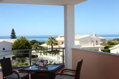 a balcony with a table and a view of the ocean at Casa Coralea in Guia