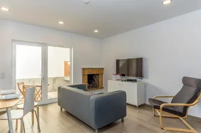 a living room with a couch and a tv at FLH Faro Central House with Terrace in Faro