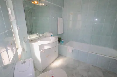 a bathroom with a toilet and a sink and a tub at Vila Girasol, 171 - Clever Details in Vilamoura