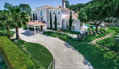 a house with a garden and a walkway at Villa Gondra - Quinta do Lago - heated pool in Almancil