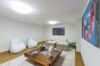 a living room with a couch and a table at Villa Gondra - Quinta do Lago - heated pool in Almancil