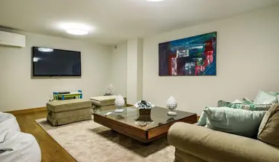 a living room with a couch and a coffee table at Villa Gondra - Quinta do Lago - heated pool in Almancil