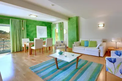a living room with a table and a couch at Marina Sand Residence in Albufeira