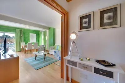 a living room with a table and a dining room at Marina Sand Residence in Albufeira