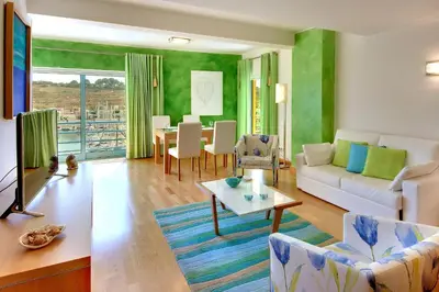 a living room with a couch and a table at Marina Sand Residence in Albufeira