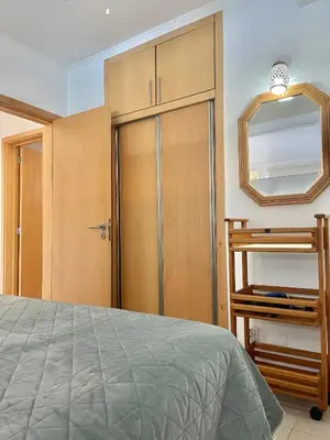 a bedroom with a closet and a mirror and a bed at Bayview Apartment 106 in Albufeira