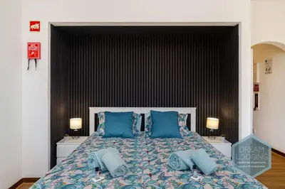 a bedroom with a large bed with blue pillows at Casa Branca 409 - Dream Lodging in Albufeira