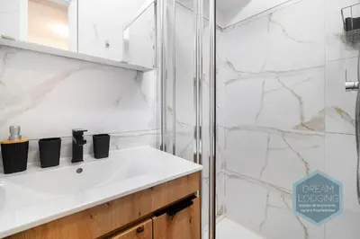 a bathroom with a white sink and a shower at Casa Branca 409 - Dream Lodging in Albufeira