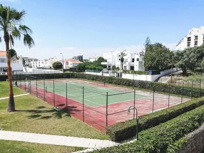 a tennis court in the middle of a park at Casa Branca 409 - Dream Lodging in Albufeira