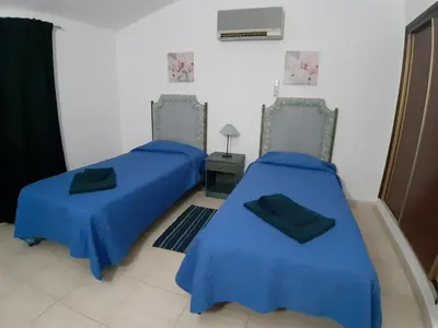two beds in a room with blue coverings at Quinta Vita - Vila Maça in Loulé