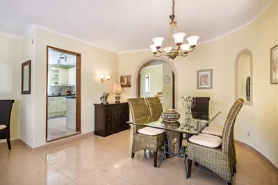 a dining room with a glass table and chairs at Amizade by Algarve Villa Holidays in Albufeira