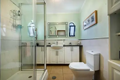 a bathroom with a shower and a toilet and a sink at Amizade by Algarve Villa Holidays in Albufeira