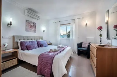 a bedroom with a bed and a desk and a chair at Apt Galé Garden AA by Algarve Villa Holidays in Albufeira