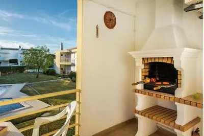 a fireplace on the balcony of a house at Apt Galé Garden AA by Algarve Villa Holidays in Albufeira