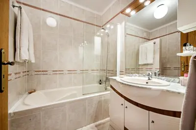 a bathroom with a tub and a sink and a bath tub at Apt O Monte AG by Algarve Villa Holidays in Albufeira