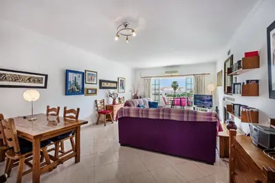a living room with a bed and a table at Apt O Monte AG by Algarve Villa Holidays in Albufeira