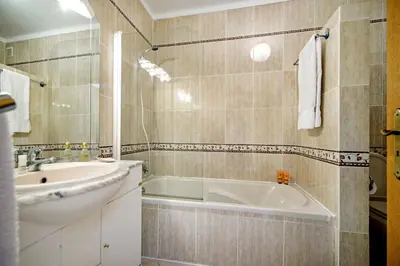 a bathroom with a sink and a bath tub at Apt O Monte AG by Algarve Villa Holidays in Albufeira