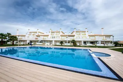 a swimming pool in front of a large building at Apt O Monte C near the beach by Algarve Villa Holidays in Albufeira