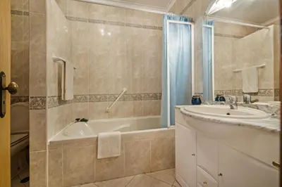 a bathroom with a tub and a sink and a bath tub at Apt O Monte C near the beach by Algarve Villa Holidays in Albufeira