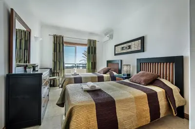 a hotel room with two beds and a television at Apt Galé Mar 11 by Algarve Villa Holidays in Galé