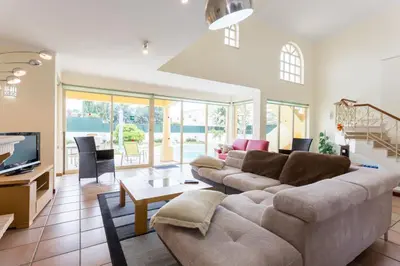 a living room with a couch and a tv at Helmar by Algarve Villa Holidays in Galé