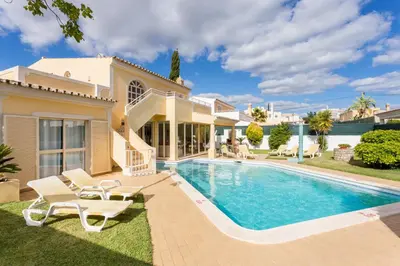 a villa with a swimming pool and a house at Helmar by Algarve Villa Holidays in Galé