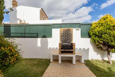 a white house with a fireplace in the yard at Helmar by Algarve Villa Holidays in Galé
