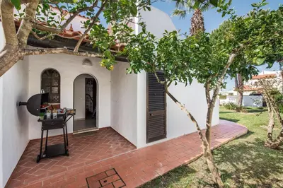 a patio with a table next to a house at Íris by Algarve Villa Holidays in Galé