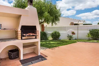 a backyard with a pizza oven in a yard at Isabel by Algarve Villa Holidays in Galé